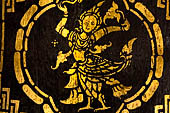 Wat Xieng Thong temple in Luang Prabang, Laos. Detail of the  intricate gold stencilling on black lacquer that decorate the walls of the sim.